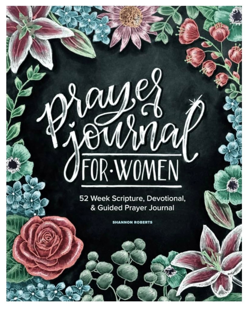 Cover of Prayer Journal for Women by Shannon Roberts: a beautiful chalk-style floral design with lilies, roses, and blooms framing the title ‘Prayer Journal for Women’ and subtitle ‘52 Week Scripture, Devotional, & Guided Prayer Journal’ on a black background – ideal Christian devotional for women’s faith, mental health, and daily prayer