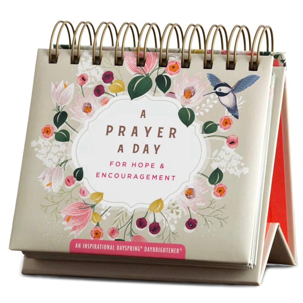 A beautiful spiral-bound perpetual daybrightener calendar titled “A Prayer a Day for Hope & Encouragement” by DaySpring, featuring a soft floral design with pink and white flowers, green leaves, berries, and a hummingbird on a neutral beige background – perfect for daily Christian inspiration, anxiety relief, and finding peace through Scripture-based prayers.