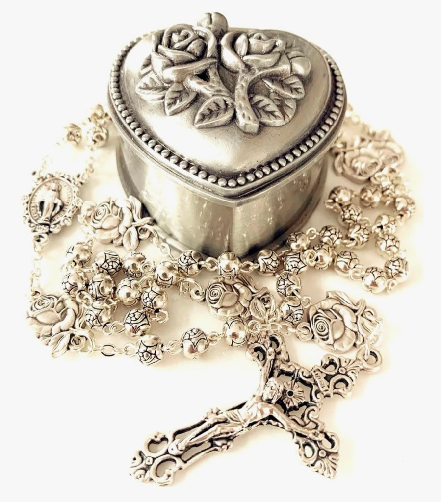 Vintage silver heart-shaped rosary box with intricate rose and cross detailing, surrounded by delicate pearl rosary beads arranged in a cross shape – perfect for Christian prayer tools and devotional essentials to deepen your faith practice (as featured in Bible study guide on worry and anxiety).