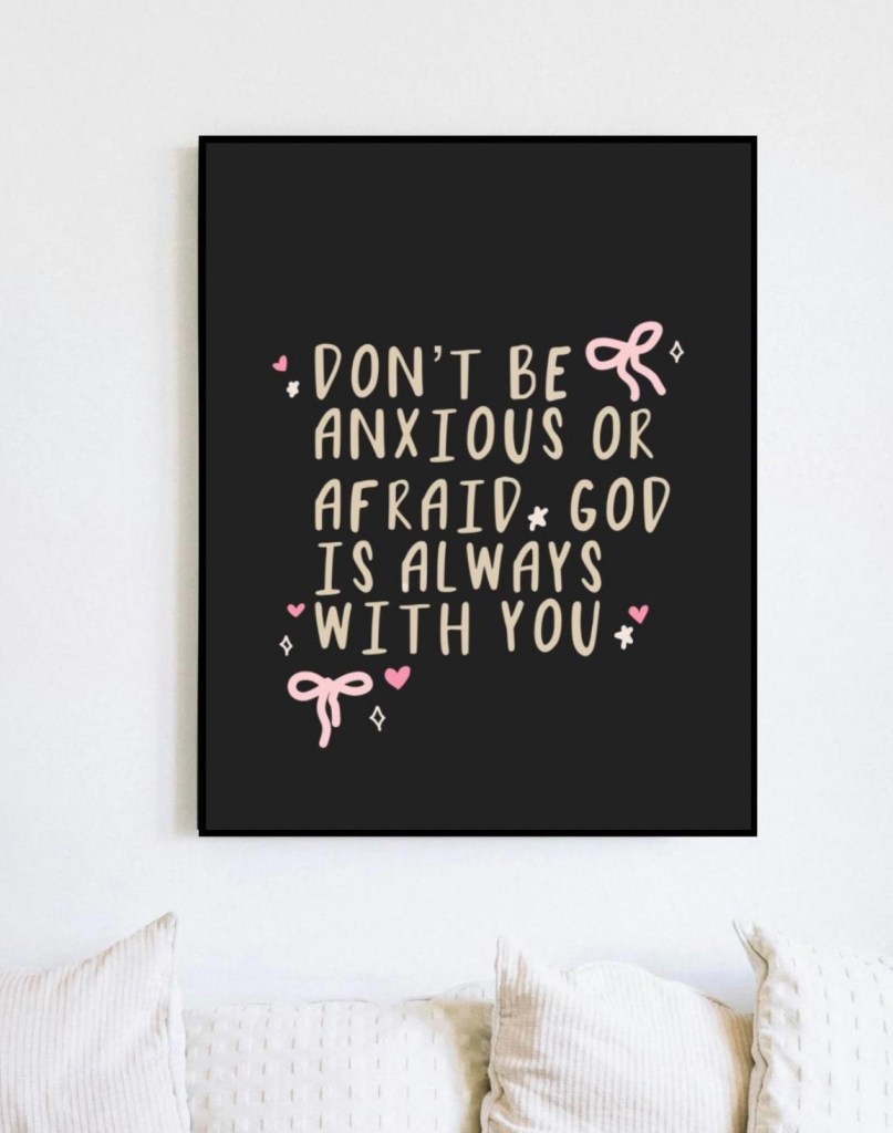 Cute pink and beige Christian wall art printable with encouraging quote “Don’t Be Anxious or Afraid, God Is Always With You” in whimsical hand-lettered font, adorned with bows, hearts, and sparkles on black background – perfect faith-based decor for overcoming worry and anxiety (as featured in Bible study guide on worry and anxiety), digital download from Etsy.