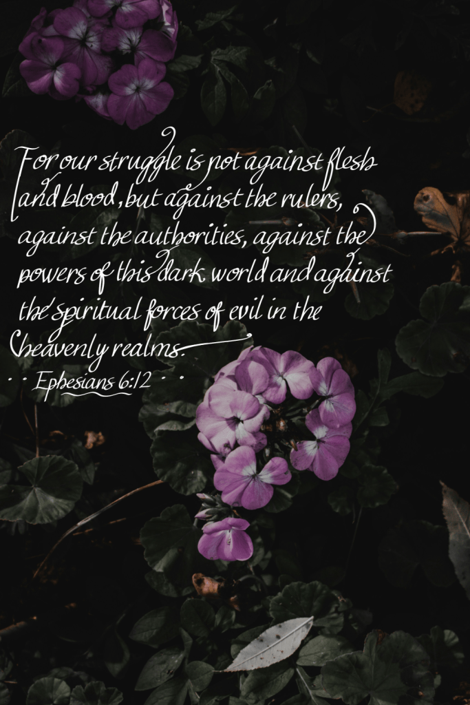 Handwritten calligraphy Bible verse art featuring Ephesians 6:12 on a dark background with purple flowers: “For our struggle is not against flesh and blood, but against the rulers, against the authorities, against the powers of this dark world and against the spiritual forces of evil in the heavenly realms.” Coping with Intrusive Thoughts from a Biblical Perspective. Inspirational Christian quote artwork. 
